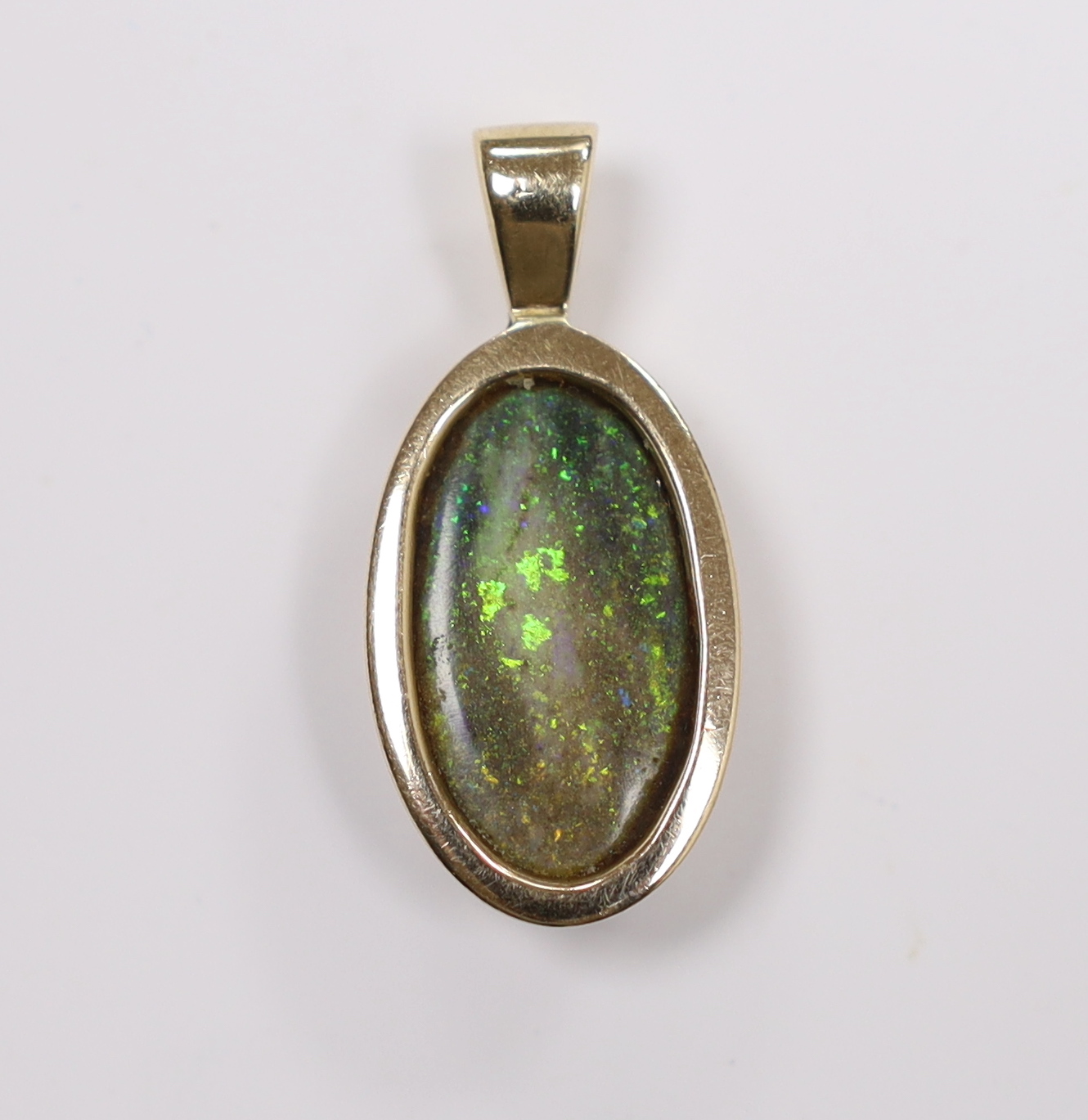 A yellow metal mounted oval black opal pendant, overall 30mm, gross weight 4 grams.